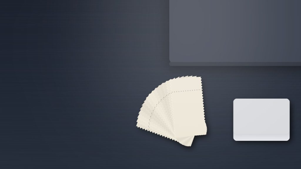 Flat editorial illustration of a fan of blank cream ticket stubs with perforated edges beside a stack of plain blank cards and the corner of a closed laptop on a dark navy desk. No logos, brands, text, faces, or real people.